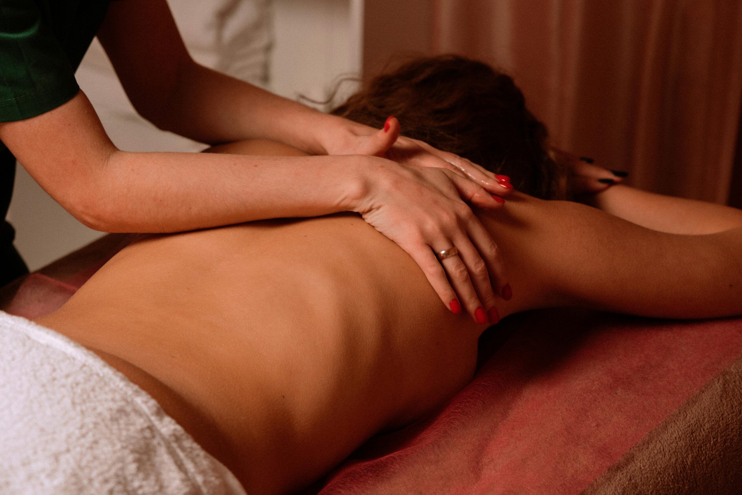 Woman receiving a professional back massage from a male therapist in Hyderabad