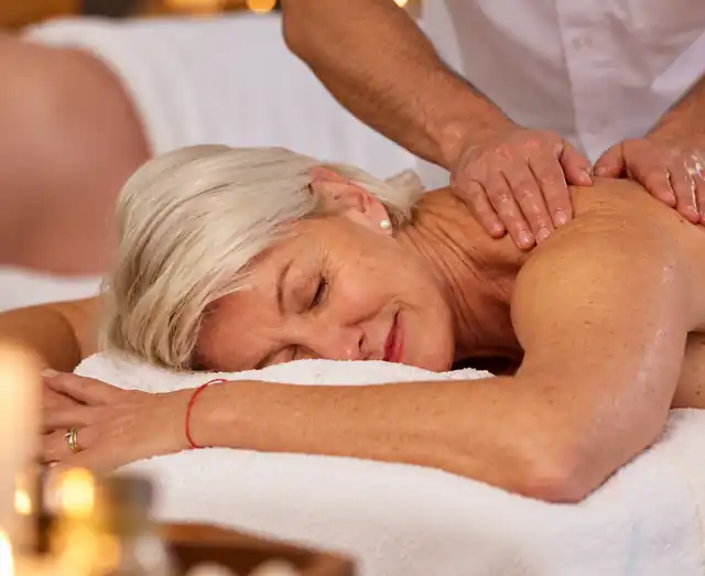 Gentle pressure massage for an older client at home in Hyderabad — light shoulder work